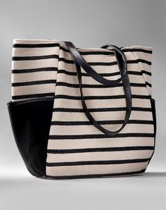 Casual and chic in a bold nautical stripe, this canvas herringbone carry all is strong and stylish. With side storage pockets, faux leather straps, full lining and pocketed interior. 100% Cotton. Everyday Striped Bags With Leather Handles, Striped Canvas Shopping Bag, Striped Bag With Leather Handles For Everyday Use, Striped Shoulder Bag With Leather Handles For Shopping, Black Travel Bag With Striped Lining, Striped Double Handle Shoulder Bag For Travel, Chic Travel Bag With Striped Lining, Canvas Bags With Striped Lining For Everyday Use, Canvas Bags With Striped Lining For Daily Use