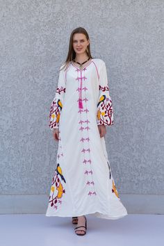 **Note : The kaftan in the video is a different color of the exact same Kaftan and is only displayed to show the fit, flow, and cut of the Kaftan. You will receive the one in the pictures.** A stunning embroidered Kaftan dress that is elegant, colorful, and unique! The dress is made of Egyptian cotton that has a soft feel to it so you will surely feel comfortable and royal in it. It also comes with a small invisible pocket on the right side of the Kaftan for added practicality.  You can wear thi Traditional Summer Maxi Length Abaya, Traditional Maxi-length Summer Abaya, Traditional Maxi Length Abaya For Summer, Traditional Maxi Length Summer Abaya, White Tunic Abaya For Summer, Bohemian Long Thobe For Spring, Traditional Embroidered Maxi Dress For Spring, White Summer Tunic Abaya, Spring Bohemian Long Thobe