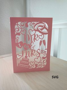 a pink card with the words mr and mrs cut out on it's side