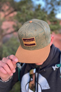 Flatbill snapback hat -- Olive/Tan. Screen printed topo map. Leather patch with CO Flag. Two-tone snapback. Olive Tan, Snapback Hat