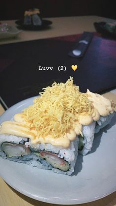 there is a sushi on the plate with sauce and shredded parmesan cheese