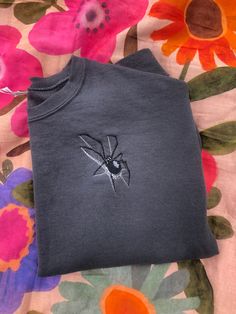 This realistic spider sweatshirt is perfect for the Halloween season. The spider is embroidered on the left chest. This is the perfect creepy sweater to add to you Fall wardrobe. Embroidered Spider, Clothes Alterations, Altering Clothes, Embroidered Crewneck, The Spider, Cute Sweatshirts, Embroidered Sweater