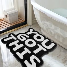 a bath tub sitting next to a rug that says yogurt hot on it