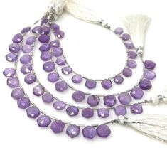 three strands of amethyst beads with tassels