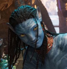 avatar from avatar with dreadlocks standing in front of an alien like creature and looking at the camera