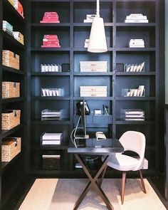 a chair and desk in front of a bookcase