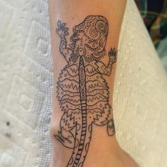 a woman's foot with a tattoo on it