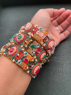 Multi Colored Stone Kara (Bangel, Cuffs, Bracelet): It has a beautiful design with multi colored stones, beads and pearls. Will fit size 2.6 and 2.8 and comes in a pair. If your unsure about your size please message me. I have a big variety of Nauratan Kara look through my listings to see the variety. Multicolor Bracelets With Motifs As Gift, Multicolor Bracelets With Motifs For Gifts, Handmade Multicolor Cuff Bracelet For Festive Occasions, Traditional Multicolor Bracelets With Intricate Design, Multicolor Bangle With Intricate Design As Gift, Festive Multicolor Cuff Bracelet For Festivals, Multicolor Fusion Style Bracelets For Party, Traditional Multicolor Bracelets With Motifs, Handmade Traditional Cuff Bracelet For Wedding