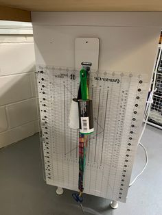 an office desk with a ruler and pen attached to the back of it's holder