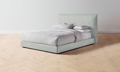 a bed sitting on top of a wooden floor