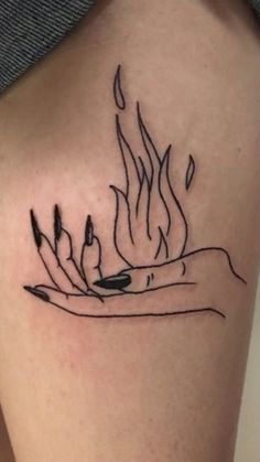 a woman's leg with a tattoo on it that has flames coming out of it