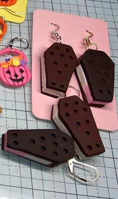 three ice cream sandwiches are sitting on a cutting board next to scissors and other crafting supplies