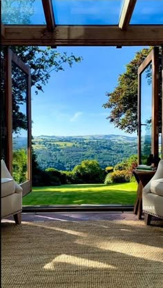 an open room with two chairs and a view