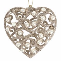 an ornament shaped like a heart with pearls in the shape of a heart