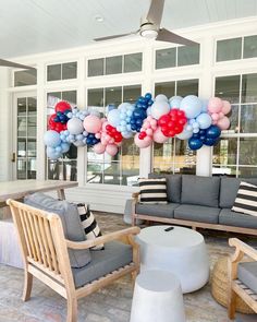 a living room filled with furniture and balloons