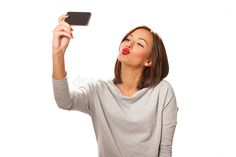 a woman taking a selfie with her cell phone stock images and clippings