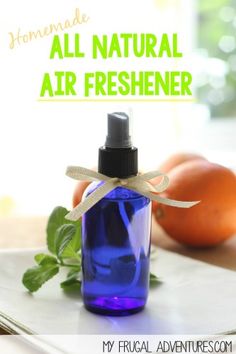 an air freshener bottle sitting on top of a cutting board next to oranges