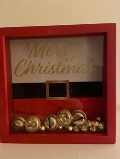 there is a red box that has some buttons in it and the words merry christmas