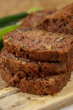 slices of chocolate zucchini bread on a cutting board with green peppers in the background