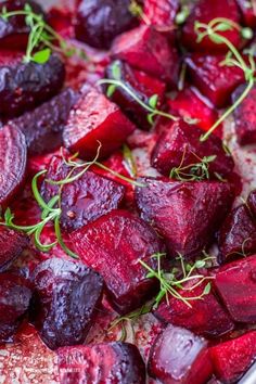 roasted beets in a pan with herbs and seasoning on top text overlay reads oven roasted beets