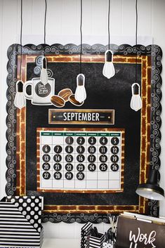 a black and white calendar with lights hanging from it's sides on a wall