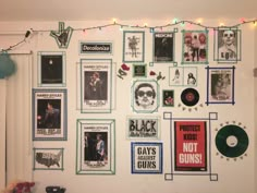 a wall covered in posters and pictures with lights