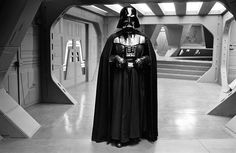 darth vader standing in the doorway of a star wars themed building with his helmet on