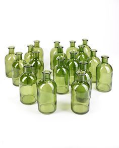 a group of green glass bottles sitting next to each other