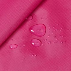 pink fabric with water drops on it