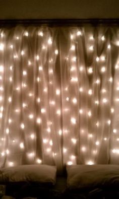 a bed covered in lights next to a window