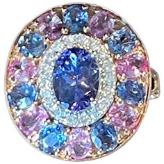 A truly a stunning display of color! These lovely and timeless Ring features a multi-color cluster of 1 oval Tanzanite weighing 1.28 ct, 7 skyblue Sapphires weighing 1.62 ct, 46 brillinat cut Diamonds weighing 0.38 ct and 7 pink Sapphires weighing 1.39 ct. Set in 18 K rose Gold. Dimensions: 2.1 cm x 1.80 cm Weight: 6.55 grams. Matching earrings and pendant available! The ring is currently size 54/14 ( american Ring size 7) but can be easily resized! QUESTIONS? Contact us right away if you have a Luxury Pink Sapphire Cluster Ring In Fine Jewelry Style, Fine Jewelry Pink Sapphire Cluster Ring With Gemstones, Luxury Pink Sapphire Cluster Ring Fine Jewelry, Fine Jewelry Pink Sapphire Diamond Ring With Multi-stones, Fine Jewelry Pink Sapphire Multi-stone Diamond Ring, Timeless Ring, Blue Sapphire Diamond, Pink Ring, Sapphire Diamond