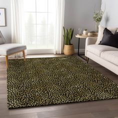 a living room with a couch, chair and leopard print rug on the hardwood floor