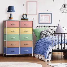 a bed room with a neatly made bed next to a chest of drawers and a rug