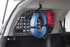 the back end of a car with two blue ropes hanging from it's trunk