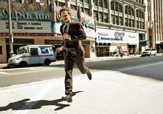 a man in a suit is running down the street