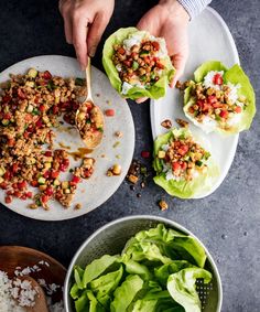 two plates filled with lettuce, meat and rice