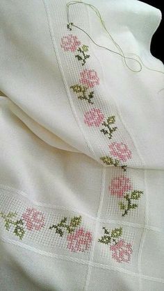 an image of a white shirt with pink flowers on it