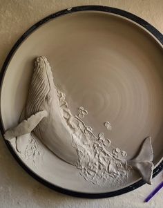 a ceramic plate with a whale tail on it