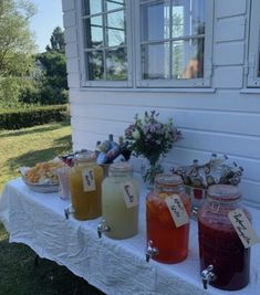 there are many jars with drinks on the table