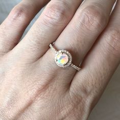 "A Vintage-Inspired bridal ring set or engagement/promise ring features a round genuine faceted fiery Opal complemented with diamond simulant accent handcrafted in your choice of metal.(r-egt-173-opal) We use the finest top-notch genuine opal with maximum fire which will have you mesmerized! Ring Info ------------------------------------------- Genuine Round Opal measure 5mm, weighs 0.55cts Shank thickness at the narrowest section 1.33mm Model's ring size 5 Silver, 10k or 14k Solid Gold Customiz Adjustable Gold Jewelry With Halo Setting, Opal Halo Wedding Jewelry, Opal Halo Jewelry With Round Shape, Round Opal Jewelry With Halo Detail, Halo Opal Jewelry With Round Shape, Opal Jewelry With Round Accent Stones, Adjustable Round Jewelry With Accent Stones, Adjustable Jewelry With Accent Stones, Rose Gold Halo Ring