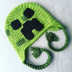 a crocheted green hat with black buttons