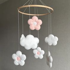 a baby crib mobile with pink and white flowers