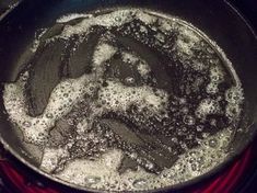 a frying pan filled with lots of oil on top of a stove burner