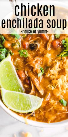 chicken enchilada soup in a white bowl with cilantro and lime