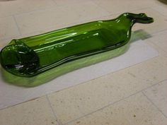 a green glass bottle sitting on top of a counter