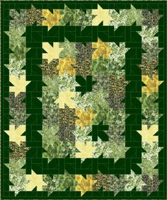 a green and yellow quilt with an arrow pattern on the center, surrounded by leaves