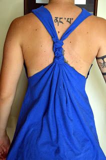 the back of a woman's blue dress with tattoos