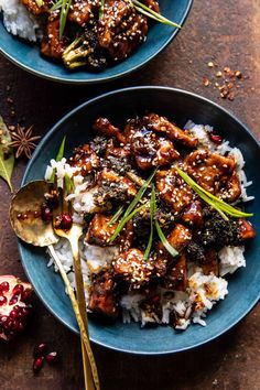 two plates filled with rice and meat covered in sauce