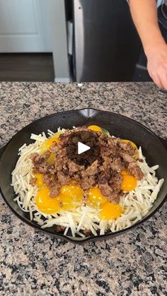 someone is cooking food in a skillet on the kitchen counter