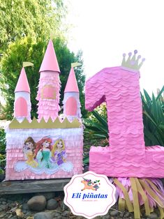 there is a pink princess birthday cake with the number one on it and other decorations